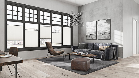 Graues Wohnzimmer mit MHZ Duette® Wabenplissee „Angelhair 8222“ an großen Sprossenfenstern.